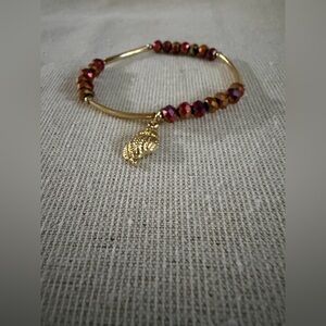 Gold Tone Bracelet with Red and Copper Beads and Leaf Charm